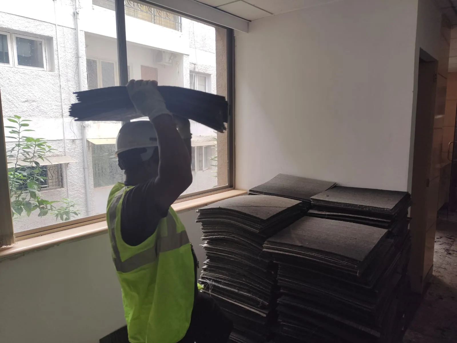 Deconstruction technicians dismantling linear workspace frames safely inside a high-rise office building on MG Road Bangalore.